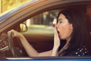 woman yawning while driving