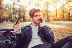 man-holding-card-on-phone