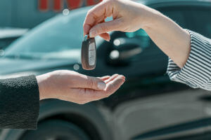 woman-hands-key-over