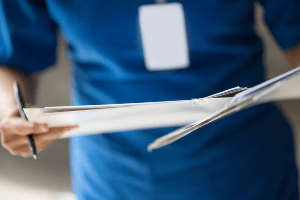nurse holding medical records file