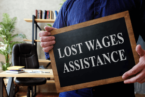 man holding a l"lost wages assistance" sign