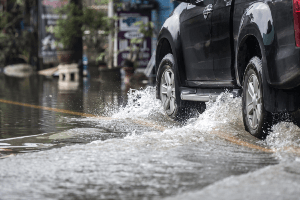 truck driving through flood waters
