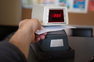 photo illustration of a hand punching in a time clock
