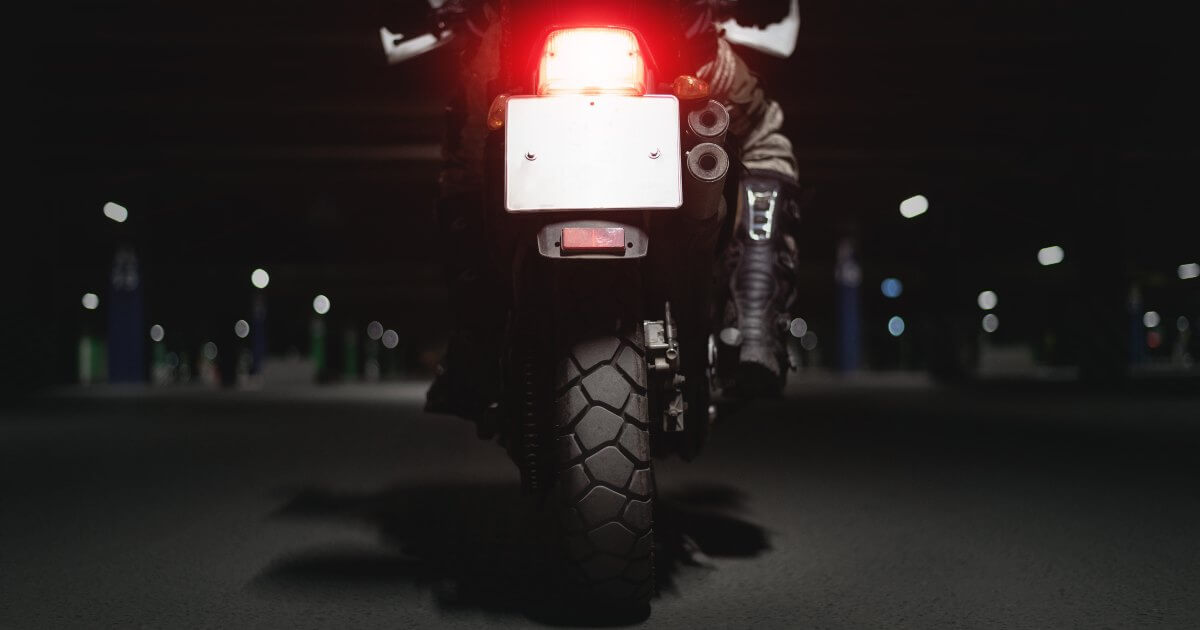 back of motorcycle on road at night