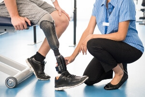 young man with prosthetic in physical therapy